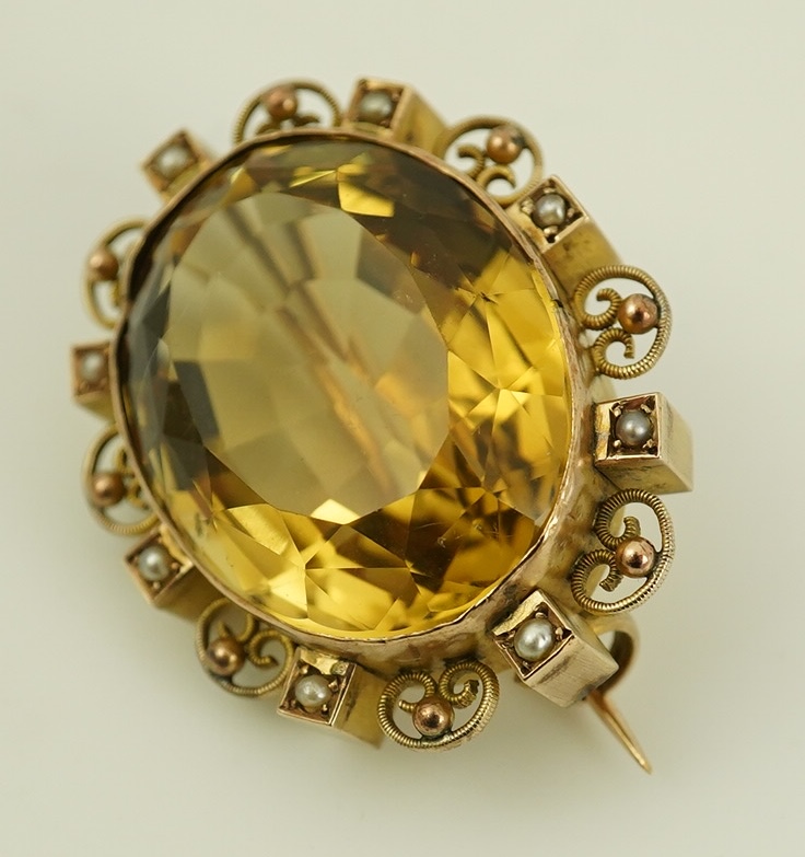 A late Victorian 9ct gold, citrine and seed pearl cluster set oval brooch